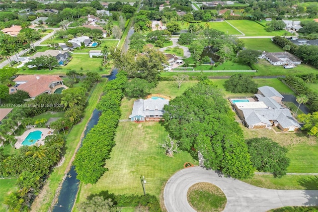 drone / aerial view with a water view and a residential view