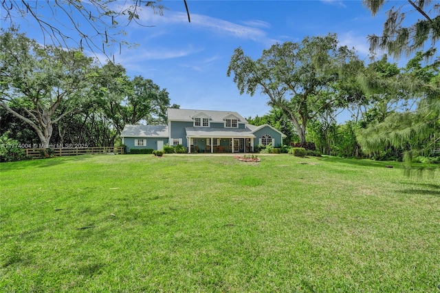 back of property featuring fence and a lawn