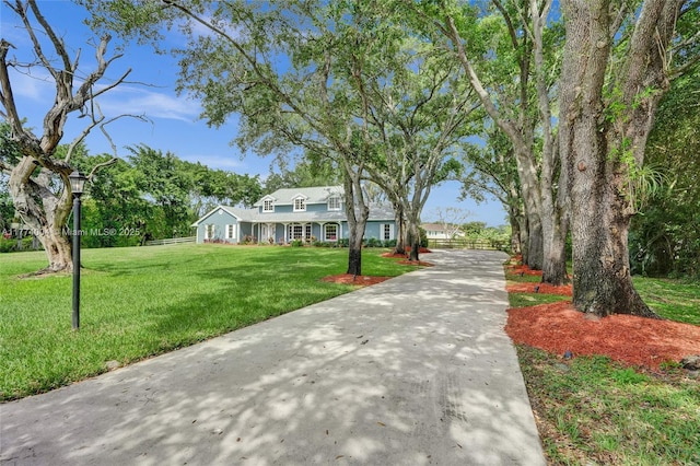 surrounding community featuring a lawn and driveway