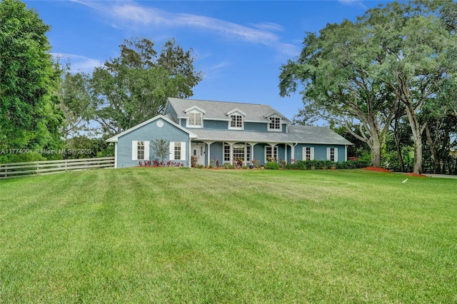 view of front of property featuring a porch, fence, and a front yard