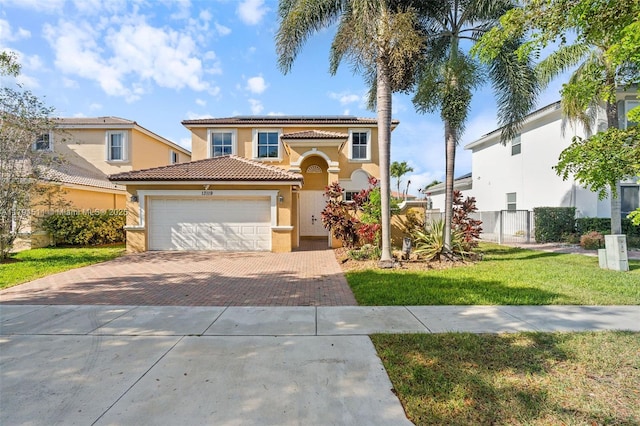 13119 SW 29th St, Miramar, FL 33027 - mediterranean / spanish house featuring stucco siding, decorative driveway, a tile roof, roof mounted solar panels, and a garage