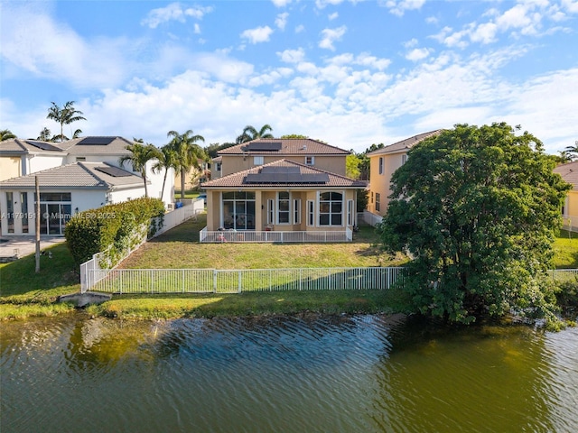 13119 SW 29th St, Miramar, FL 33027 - rear view of property with solar panels, a water view, a tile roof, and a fenced backyard