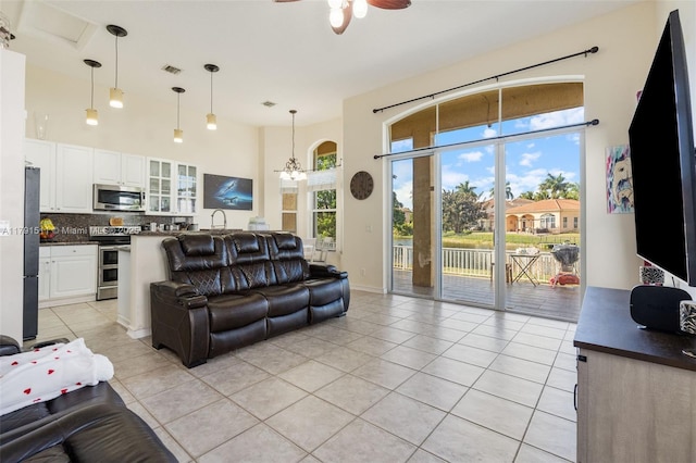 13119 SW 29th St, Miramar, FL 33027 - living area featuring light tile patterned floors, ceiling fan, and a towering ceiling