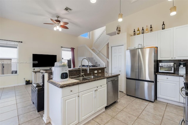 13119 SW 29th St, Miramar, FL 33027 - kitchen with stainless steel appliances, light tile patterned floors, a ceiling fan, and plenty of natural light