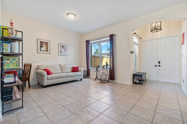 13119 SW 29th St, Miramar, FL 33027 - living area with light tile patterned flooring, arched walkways, and a chandelier