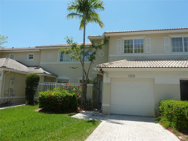 view of front of house with a garage, stucco siding, and a tiled roof