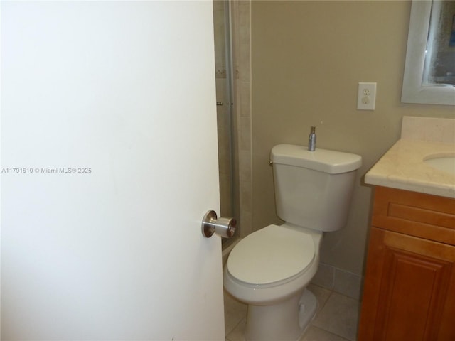 full bath with toilet, vanity, and tile patterned flooring