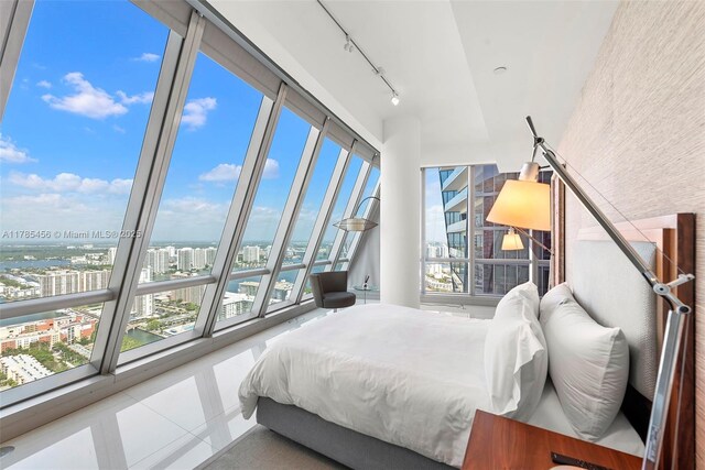 17121 Collins Ave Unit Ph4806, Sunny Isles Beach, FL 33160 - bedroom with a city view, multiple windows, tile patterned flooring, and rail lighting