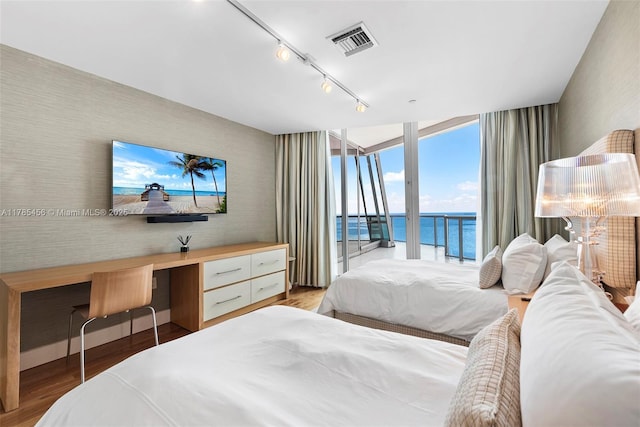 17121 Collins Ave Unit Ph4806, Sunny Isles Beach, FL 33160 - bedroom with access to outside, wallpapered walls, expansive windows, wood finished floors, and track lighting