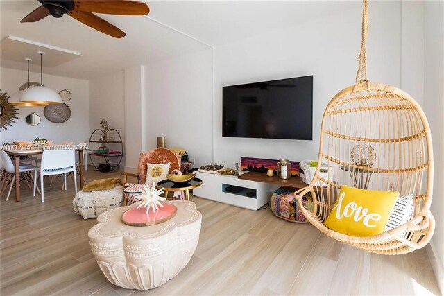 10275 Collins Ave Unit 219, Bal Harbour, FL 33154 - living area featuring a ceiling fan and wood finished floors