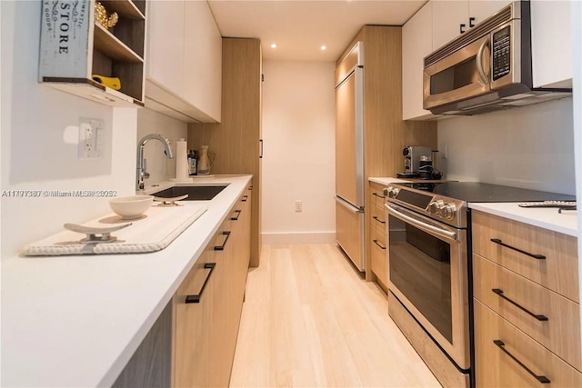10275 Collins Ave Unit 219, Bal Harbour, FL 33154 - kitchen featuring light wood finished floors, a sink, stainless steel appliances, light brown cabinetry, and light countertops
