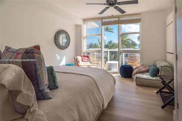 10275 Collins Ave Unit 219, Bal Harbour, FL 33154 - bedroom with a ceiling fan and wood finished floors