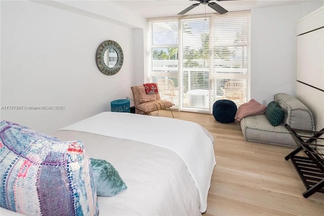 10275 Collins Ave Unit 219, Bal Harbour, FL 33154 - bedroom featuring a ceiling fan and light wood-style flooring