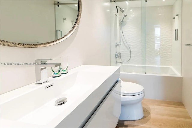 10275 Collins Ave Unit 219, Bal Harbour, FL 33154 - bathroom with washtub / shower combination, vanity, and toilet