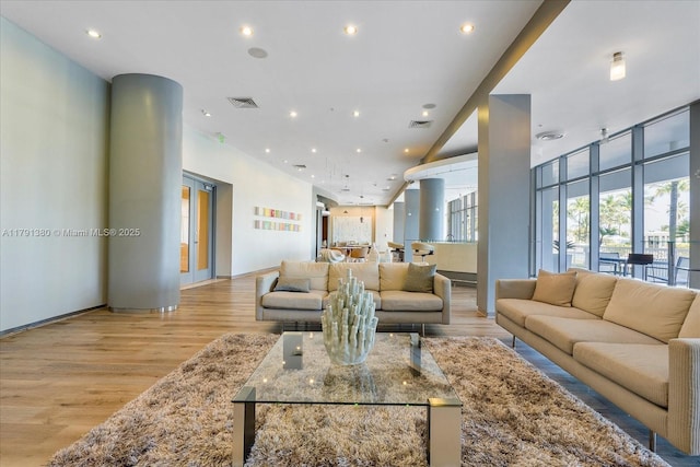 10275 Collins Ave Unit 219, Bal Harbour, FL 33154 - living area with recessed lighting, visible vents, baseboards, and light wood-type flooring