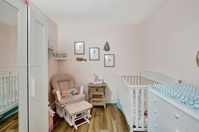 17501 NW 85th Ave, Hialeah, FL 33015 - bedroom with light wood-style floors and a crib