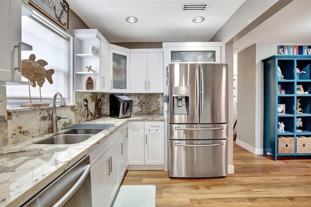 17501 NW 85th Ave, Hialeah, FL 33015 - kitchen with stainless steel appliances, white cabinetry, decorative backsplash, light stone counters, and recessed lighting