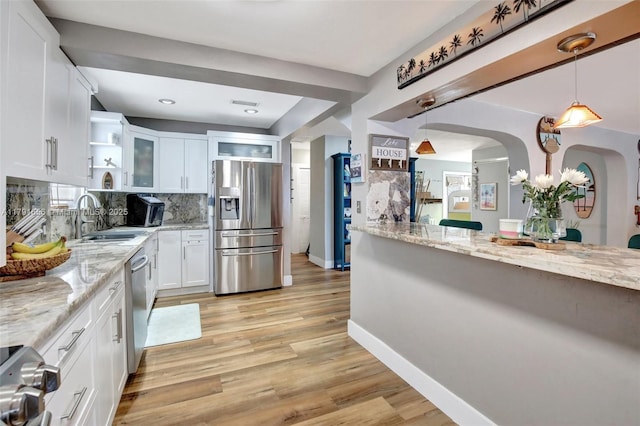 17501 NW 85th Ave, Hialeah, FL 33015 - kitchen with white cabinets, light stone counters, appliances with stainless steel finishes, and a sink