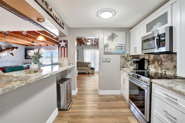 17501 NW 85th Ave, Hialeah, FL 33015 - kitchen with appliances with stainless steel finishes, backsplash, light wood-type flooring, white cabinets, and glass insert cabinets