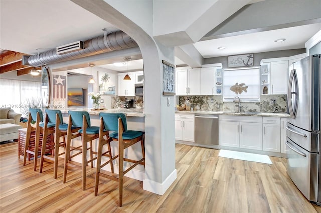 17501 NW 85th Ave, Hialeah, FL 33015 - kitchen featuring white cabinetry, appliances with stainless steel finishes, light wood finished floors, and a sink