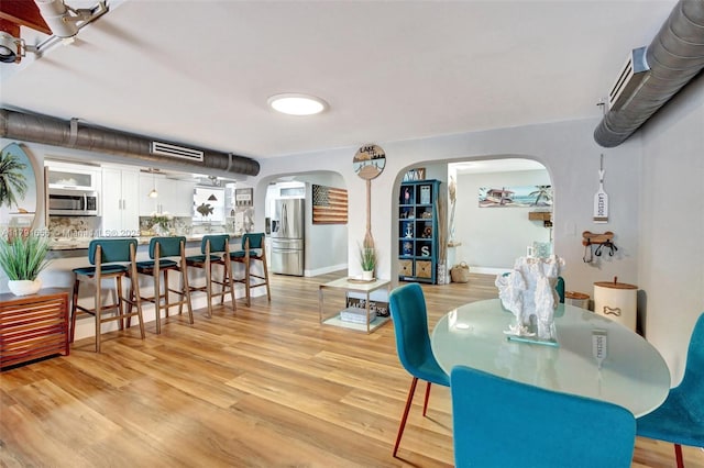 17501 NW 85th Ave, Hialeah, FL 33015 - dining room featuring arched walkways and light wood-type flooring