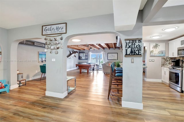 17501 NW 85th Ave, Hialeah, FL 33015 - kitchen with arched walkways, stainless steel appliances, white cabinets, billiards, and light wood finished floors