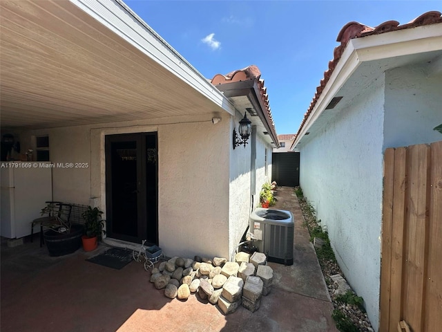 11537 SW 6th St, Sweetwater, FL 33174 - view of property exterior with a patio area, central AC unit, a tiled roof, stucco siding, and fence