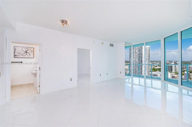 1900 N Bayshore Dr Unit 2816, Miami, FL 33132 - unfurnished room featuring expansive windows, light tile patterned floors, and a city view