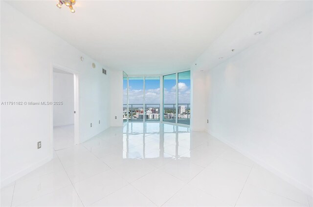 1900 N Bayshore Dr Unit 2816, Miami, FL 33132 - empty room with expansive windows and light tile patterned flooring