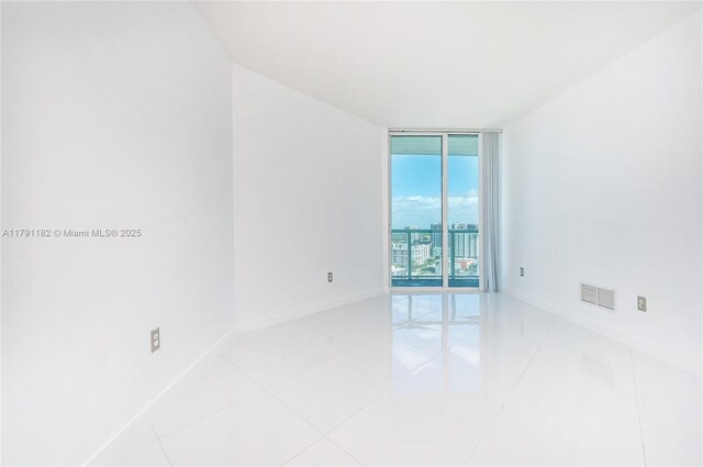 1900 N Bayshore Dr Unit 2816, Miami, FL 33132 - spare room featuring expansive windows, baseboards, and light tile patterned floors