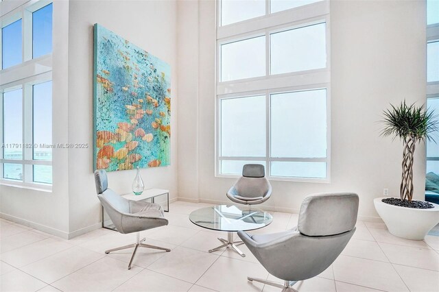 1900 N Bayshore Dr Unit 2816, Miami, FL 33132 - sitting room featuring tile patterned flooring, a towering ceiling, and baseboards