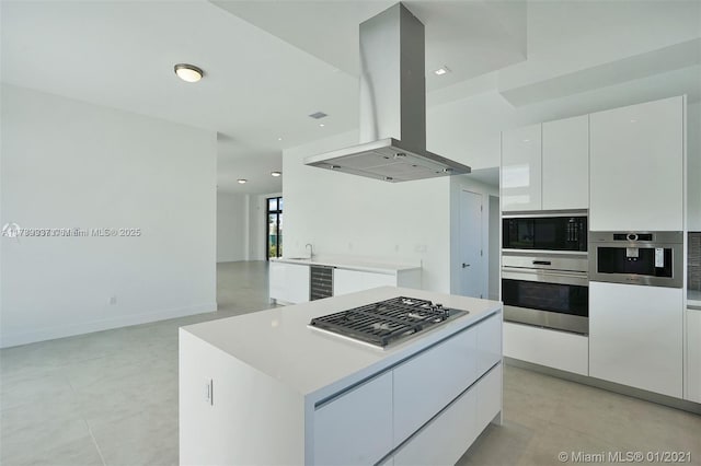 16512 Botaniko Dr S, Weston, FL 33326 - kitchen with modern cabinets, island range hood, appliances with stainless steel finishes, and white cabinets