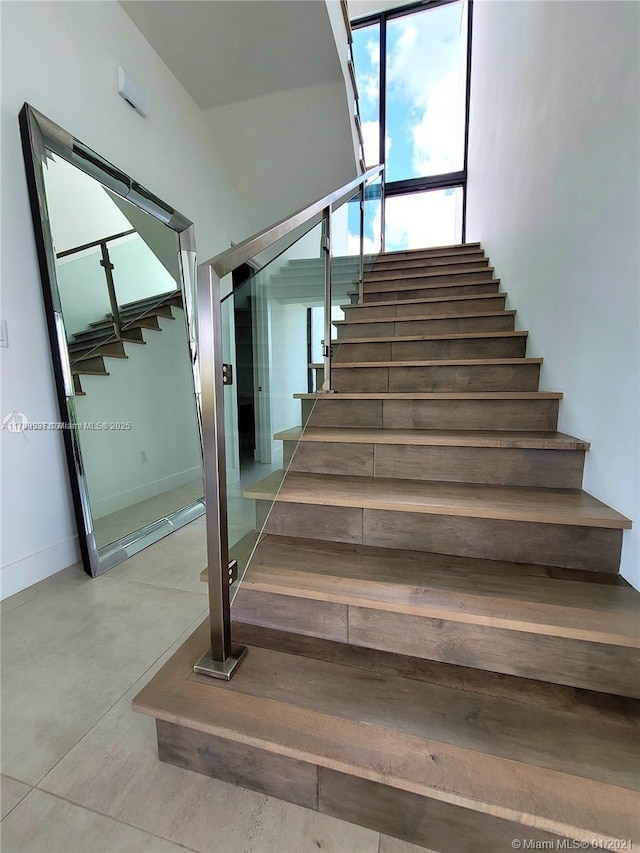 16512 Botaniko Dr S, Weston, FL 33326 - stairs with baseboards and finished concrete floors