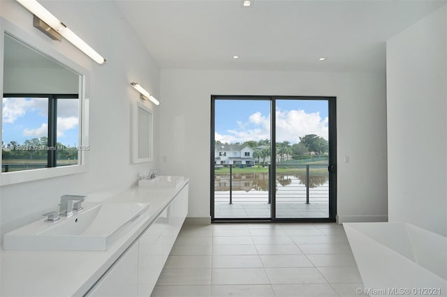 16512 Botaniko Dr S, Weston, FL 33326 - full bathroom with recessed lighting, a sink, a water view, double vanity, and tile patterned flooring