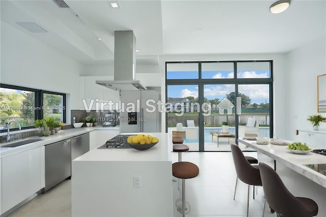 16512 Botaniko Dr S, Weston, FL 33326 - kitchen with island exhaust hood, dishwasher, a sink, and white cabinetry