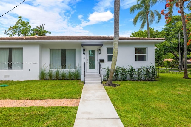 701 NE 119th St, Biscayne Park, FL 33161 - view of front of home featuring stucco siding and a front lawn