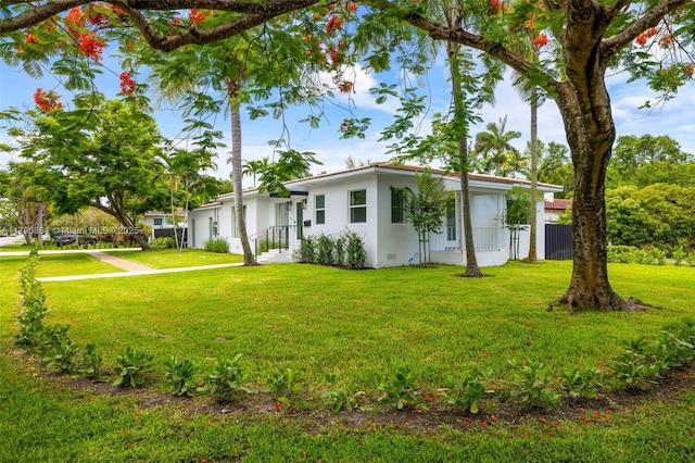 701 NE 119th St, Biscayne Park, FL 33161 - view of front facade featuring a front lawn and stucco siding