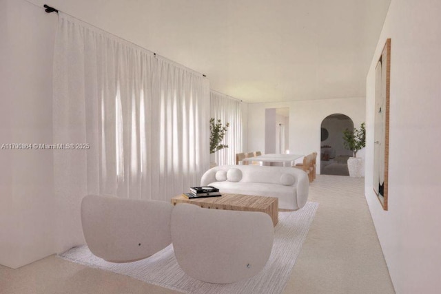 701 NE 119th St, Biscayne Park, FL 33161 - living room featuring carpet floors and arched walkways