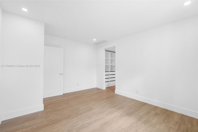 701 NE 119th St, Biscayne Park, FL 33161 - spare room featuring recessed lighting, light wood-style floors, and baseboards
