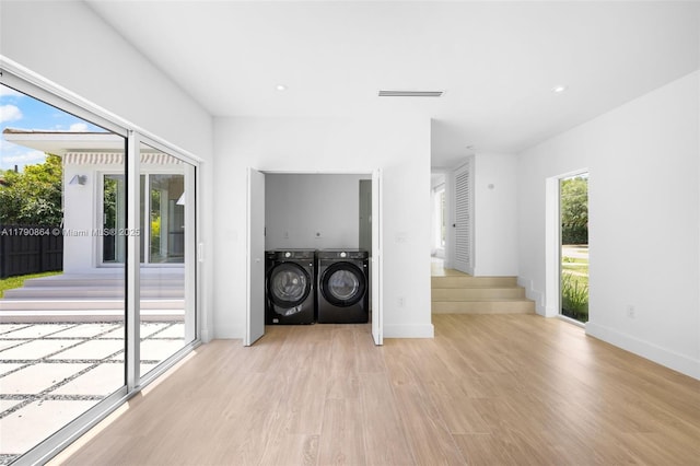 701 NE 119th St, Biscayne Park, FL 33161 - laundry area featuring light wood-style floors, washing machine and dryer, baseboards, and recessed lighting