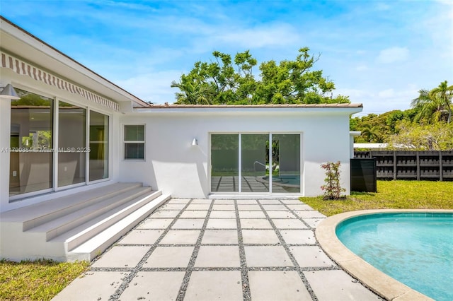 701 NE 119th St, Biscayne Park, FL 33161 - back of house featuring stucco siding, a patio, and an outdoor pool