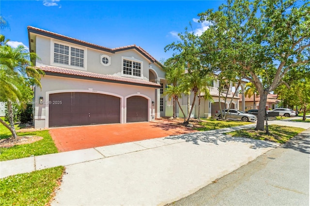 17937 SW 36th St, Miramar, FL 33029 - mediterranean / spanish home featuring an attached garage, stucco siding, driveway, and a tile roof