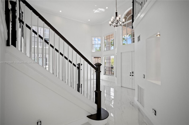 17937 SW 36th St, Miramar, FL 33029 - entrance foyer featuring crown molding, marble finish floor, a towering ceiling, stairs, and a chandelier