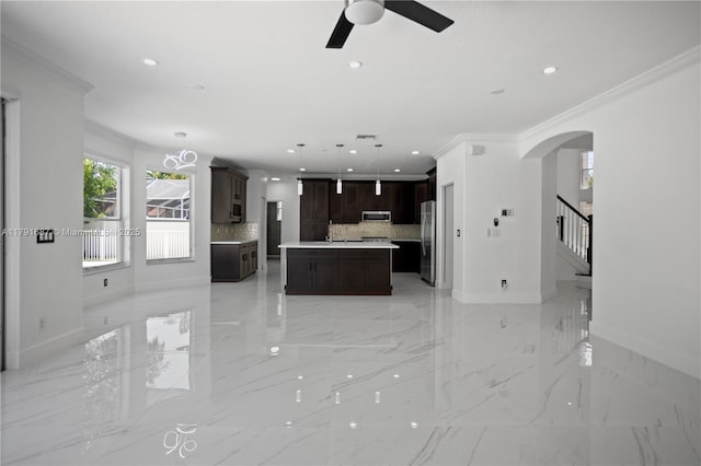 17937 SW 36th St, Miramar, FL 33029 - unfurnished living room with baseboards, arched walkways, a ceiling fan, and crown molding