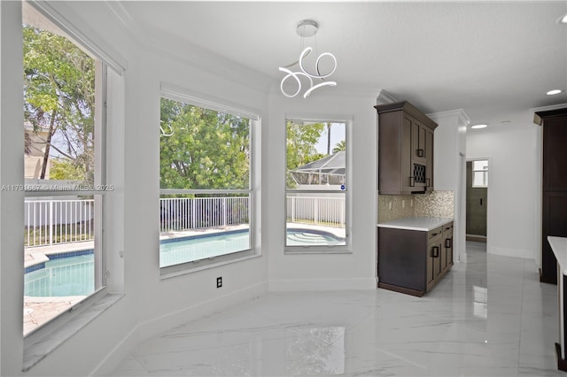 17937 SW 36th St, Miramar, FL 33029 - kitchen with backsplash, dark brown cabinets, light countertops, baseboards, and marble finish floor