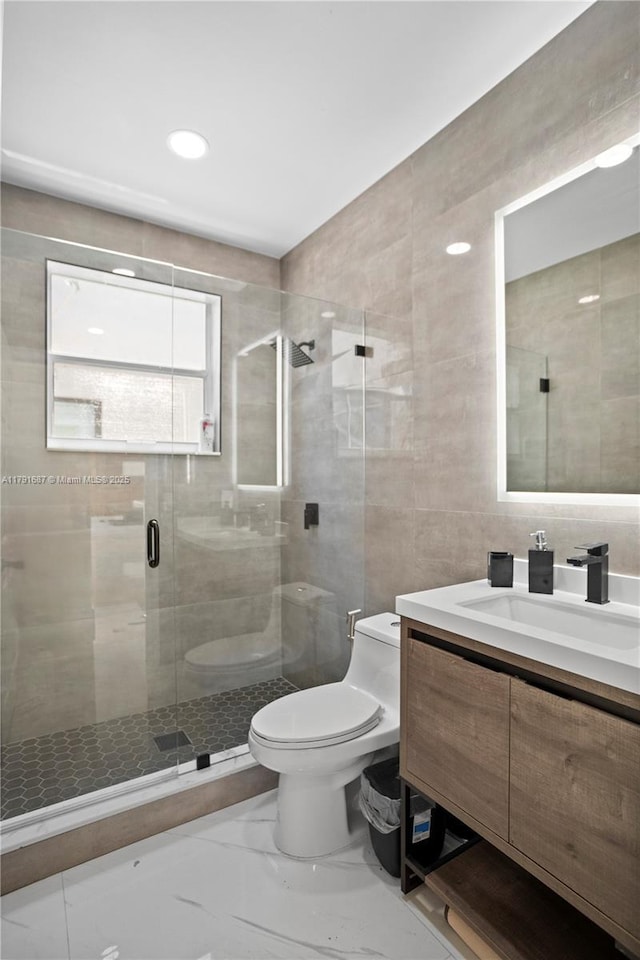 17937 SW 36th St, Miramar, FL 33029 - bathroom featuring tile walls, a stall shower, vanity, toilet, and marble finish floor
