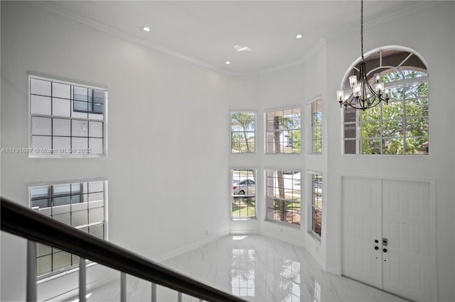 17937 SW 36th St, Miramar, FL 33029 - entrance foyer featuring crown molding, marble finish floor, a chandelier, and a wealth of natural light
