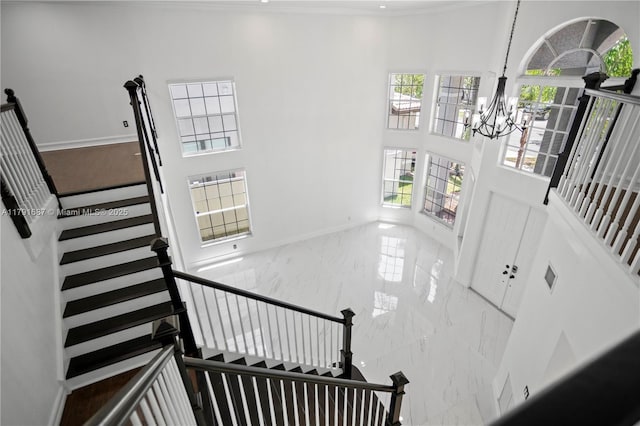 17937 SW 36th St, Miramar, FL 33029 - stairway featuring baseboards, a high ceiling, marble finish floor, and a notable chandelier