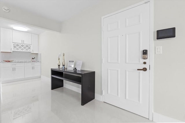 7153 Promenade Dr Unit 302, Boca Raton, FL 33433 - kitchen featuring white cabinetry, light tile patterned floors, and baseboards