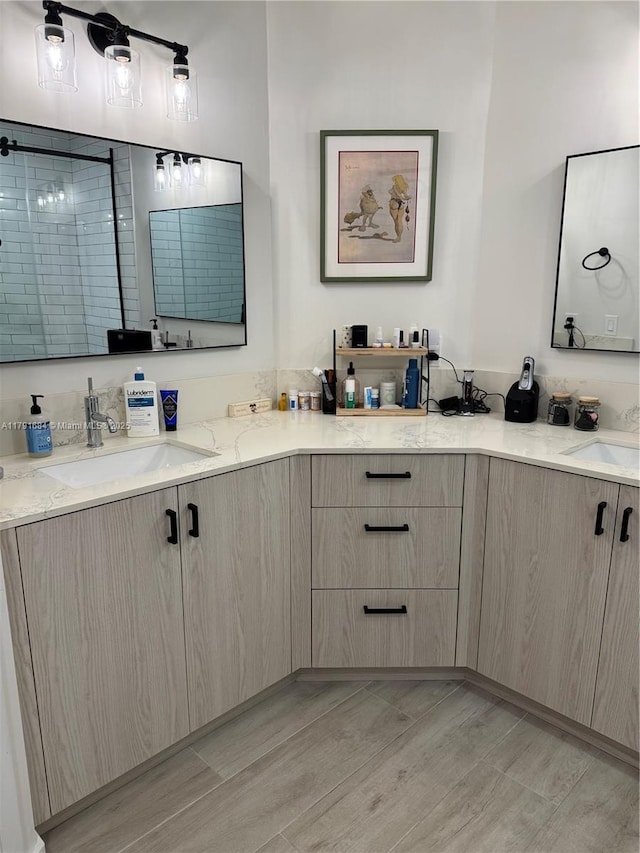 15533 N Miami Lakeway N Unit 101-19, Miami Lakes, FL 33014 - bathroom featuring double vanity, tiled shower, a sink, and wood finished floors